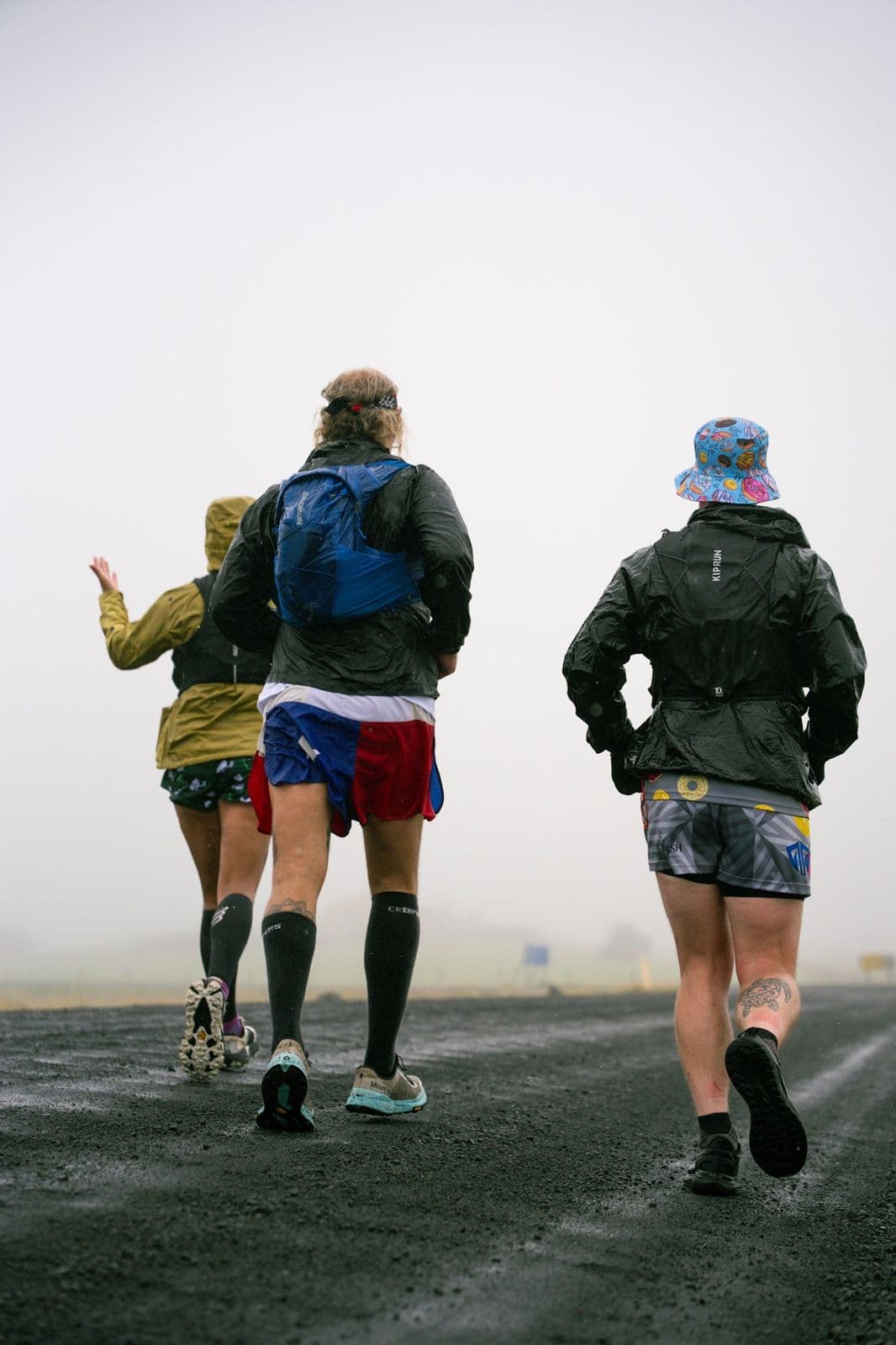 Three runners from behind on a foggy road