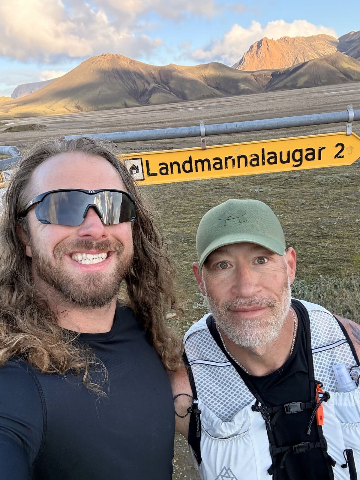 Justin and a runner grinning at the Landmannalaugar sign