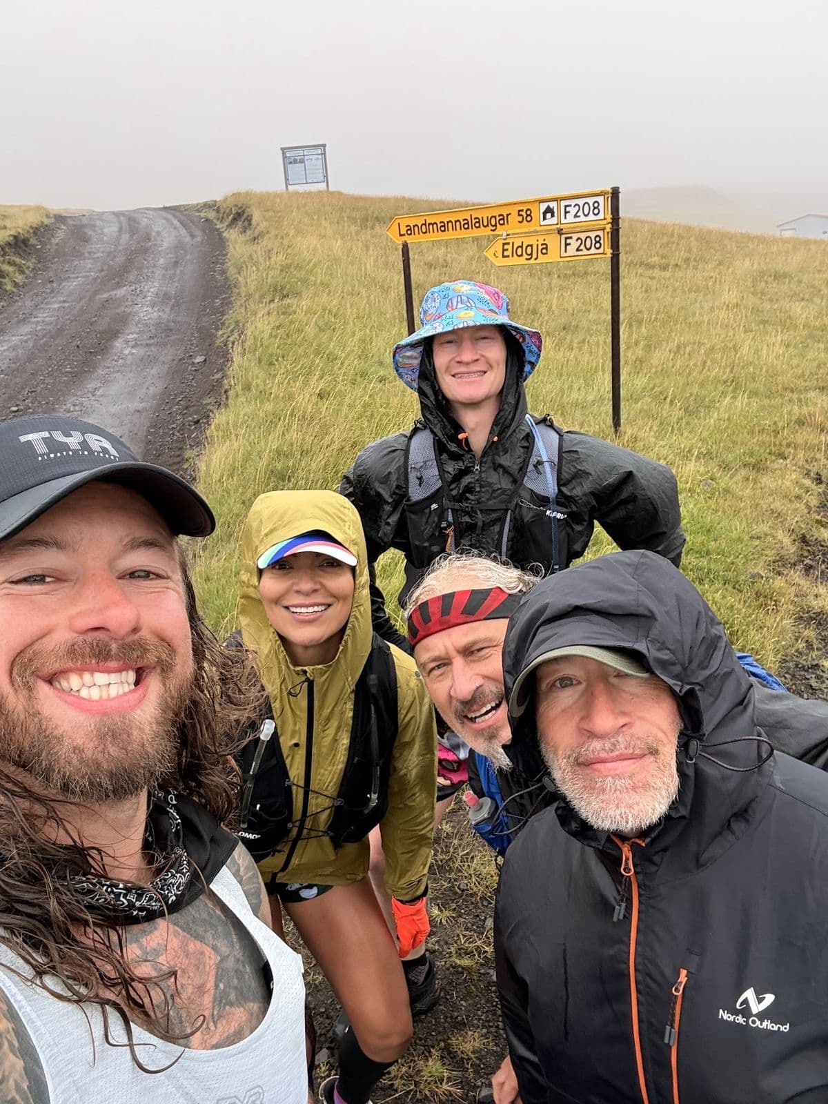 Soaked, smiling crew selfie in the rain